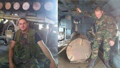 A member of the sectarian militia Hezbullah poses inside an Assad helicopter before he drops a barrel bomb onto Syrians below. 