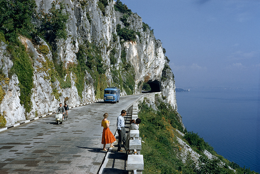 Motorists pass people on a scenic road atop a cliff overlooking a bay near Trieste, Italy, 1956.Photograph by B. Anthony Stewart, National Geographic Creative