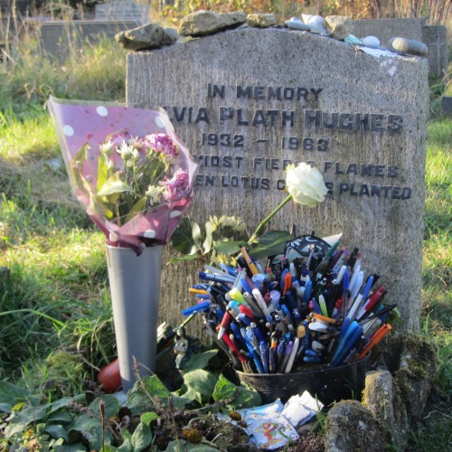Picture via Peter K. Steinberg&rsquo;s blog post from 27 October 2012 &ldquo;Gail Crowther visits Heptonstall on Sylvia Plath&rsquo;s Birthday&rdquo;***The “Sylvia Plath Calendar” - 52 years ago today:According to her death certificate, Sylvia Plath&rsquo;s funeral took place on Monday 18 February 1963 in Heptonstall&rsquo;s parish churchyard of St Thomas the Apostle, the new St Thomas á Beckett’s churchyard; near Ted Hughes’ birthplace Mytholmroyd in West Yorkshire, England.Her epitapth reads: &ldquo;Even amidst fierce flames the golden lotus can be planted.&rdquo; (More on that here).In her memoir Giving Up: The Last Days of Sylvia Plath (which I am not the biggest fan of, but it still contains a few interesting facts), Jillian Becker, Sylvia Plath&rsquo;s friend, whom Plath spend her last days with, devotes a whole chapter to Sylvia Plath&rsquo;s funeral. I compiled the most interesting passages for you:&ldquo;Sylvia had pictured her grave in undulating Devon, not fliny Yorkshire where she lies. Soon after we met she told me, speaking of her death as a far-off event, that she&rsquo;d like to be buried in the churchyard next to Court Green. Had she never said as much to Hughes? I suppose if he&rsquo;d held the funeral down there, none of his family would have come to it.&rdquo; (p. 25)&ldquo;The service in the church was short. For a few moments sunlight came through a stained-glass window, enriching the yellow in it. We followed her coffin to the grave, a yellow trench in the snow, it&rsquo;s banked up mud the same colour as the stained-glass, but thick as oil-paint freshly poured out. Beside it the rite was completed. &lsquo;I&rsquo;ll stay here alone for a while,&rsquo; Hughes said.[&hellip;]He rejoined the funeral guests soon after we were seated, fourteen or so in all, round a table in a private upper room of a pub in the village.[&hellip;]Only four of us were there 'for Sylvia&rsquo;: Warren [Sylvia Plath&rsquo;s brother] and Margaret, Gerry and I. The rest were there 'for Ted&rsquo; [&hellip;].[&hellip;]When the tea had been poured and steak-and-kidney pies sat down at each place, Hughes blurted out vehemently but quietly, as if only for Gerry and me to hear though he looked at neither of us: 'Everybody hated her.&rsquo; [&hellip;]'It was either her or me,&rsquo; he said [&hellip;].&rdquo; (p. 26)&ldquo;A moment came when he seemed to feel a need to vindicate himself to Gerry and me. He said: 'I told her everything was going to be all right. I said that by summer we&rsquo;d all be back together at Court Green.&rsquo; &rdquo; (p. 27)&ldquo;In another burst of speech he asked me it I&rsquo;d read The Bell Jar. I told him I had. And did I know that it was autobiographical? I did. So I also knew that she&rsquo;d tried to kill herself before they&rsquo;d met? I did. 'It was in her, you see,&rsquo; he said. 'But I told her that if she wrote about it profoundly enough, she would conquer it.&rsquo;'And you don&rsquo;t think she wrote about it profoundly enough?&rsquo;'No.&rsquo; His 'no&rsquo; was a sort of verbal shrug, implying: 'obviously not - doesn&rsquo;t this funeral prove it?&rsquo; &rdquo; (p. 28) 