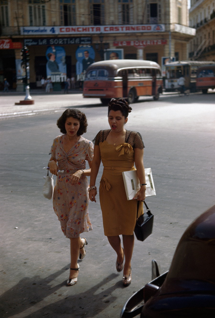 Two women on a shopping trip walk across a street in Havana, Cuba, 1947.Photograph by Melville B. Grosvenor, National Geographic Creative
