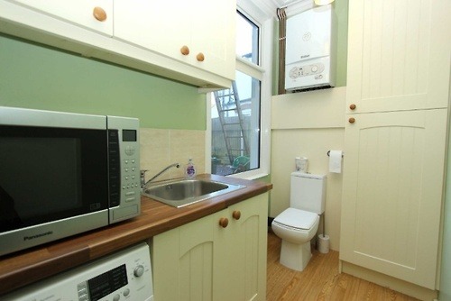 If you&#8217;re the sort of person who doesn&#8217;t mind defecating in a kitchen, then you probably won&#8217;t mind doing it next to a large window either.
Follow on Twitter @BadRealtyPhotos