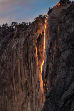 wonderous-world:  In Yosemite National Park, United States, Horsetail Falls glows orange during February. It looks like lava but its the color of the sun reflecting off the delicate waterfall that creates the radiate glimmer. Ben Neumann Photography