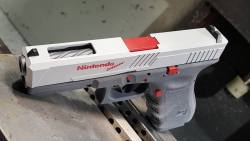 weaponslover:    Glock made to look like Nintendo Zapper   Remember all of those Nintendo Wii-mote fail videos where people would destroy their televisions by throwing the controller? This could take that to a whole new level.. source 