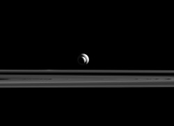 antikythera-astronomy:  Alien AlignmentTethys and Enceladus, moons of Saturn, align almost perfectly for this photograph by Cassini.(Image credit: NASA/JPL-Caltech/Space Science Institute)