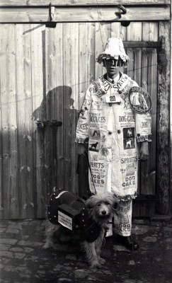 Portrait of a young man in fancy dress advertising Spratts dog cakes, circa 1900.