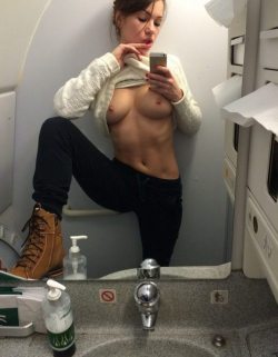 Girls snapping herself in an airplane toilet 