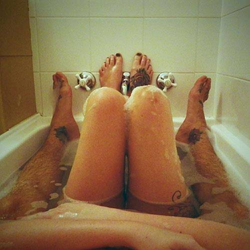 A couple having steamy lesbian in the bath foreplay