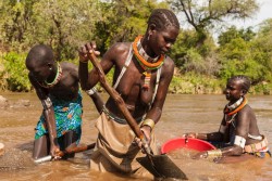  Toposa women pan for gold in the River Singaita in Namorinyang, Eastern Equatoria, South Sudan, November 27, 2013. 