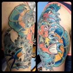 dorkly:  Magikarp / Gyarados Tattoo A reminder to never underestimate anyone.  WTF? A Magikarp tattoo? Fuck that shit. A Charizard, NOW THAT&rsquo;S AWESOME!
