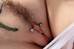 pussymodsgalore  Pussy with a clithood piercing with a curved barbell. Actually I think it is deep enough to be under the clit, if so it is a triangle piercing. The much more common piercing, above the clit, is a HCH (Horizontal Clit Hood) piercing. 
