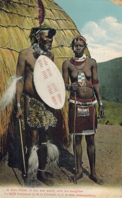 the-two-germanys:  A Zulu chief in full war paint, with his daughter.Postcard, Union of South Africa.