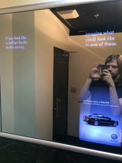 nickgoeshere:  Here’s an example of sexism in the media. It’s very subtle, but it’s insidious, and it’s everywhere. Men’s washroom and women’s washroom, each with an ad in the mirror. Both ads are for the same car. However, the text is slightly
