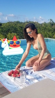 celebrityplunge:  Olivia Munn spilling out of her plunging one piece