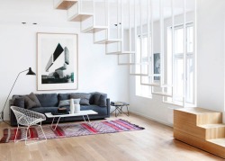 mymodernmet:  When the owners of a top-floor apartment in Olso, Norway purchased the loft above it, they wanted to unify the two floors. Known as Idunsgate, the space was revamped by the architecture firm Haptic, who installed a stunning, suspended stairc