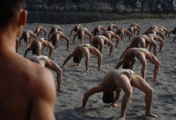 unrar:    Frogmen practice backbends on a beach to strengthen their muscles, Taiwan, Frank and Helen Schreider.
