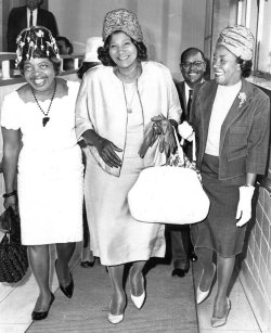 classicladiesofcolor:  In New Orleans, Louisiana famed gospel singer Mahalia Jackson, center, is joined at Moisant Airport by friends, Mrs. Elliot Von J. Beal, left, hat designer, and Mrs. Harold Francis, a local realtor, on June 10, 1966.  Jackson
