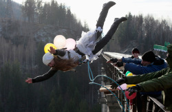 Do you wanna live forever? (A woman takes a bungee leap off a 144 foot high bridge near Krasnoyarsk, Russia)