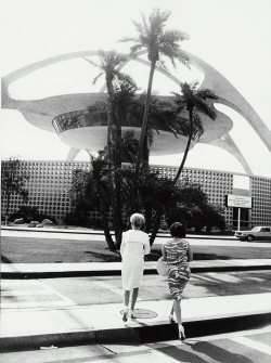 midcenturymodernfreak:  1964 With his trademark tilted horizon, Garry Winogrand’s photograph of two women in front of the Theme Building by architects William Pereira, Paul R. Williams, Charles Luckman, &amp; Welton Becket | Los Angeles International