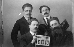  André Breton, René Hilsum, Louis Aragon and Paul Eluard posing with a copy of Dada 3, 1919. 