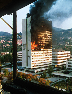 The parliament building of Bosnia and Herzegovina burns amid theYugoslav wars.