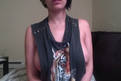twentysomethinghussy:   I love sitting home alone wearing this shirt without a bra. Happy May!  Looks like your piercings are trying to get a view of the outside world. Love it. Awesome outfit.