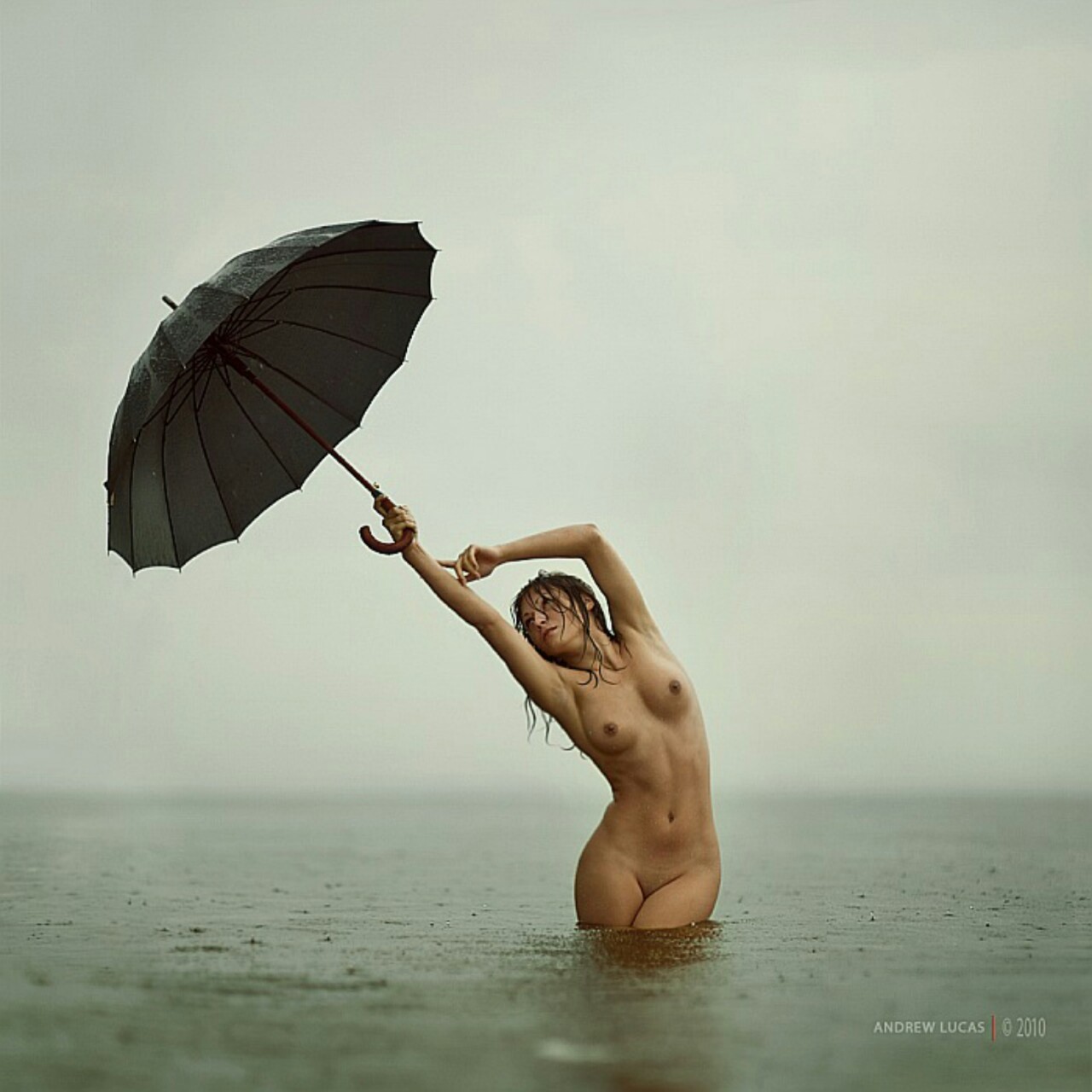 Nude girl with umbrella