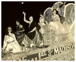 Gay Dawn waves to the crowd from the very top of a float promoting the &lsquo;RIVOLI Theatre&rsquo;; in Seattle, Washington.. The parade was an annual event (sponsored by the local Chamber Of Commerce) and part of the city&rsquo;s &ldquo;Sea Fair week&rdq