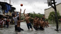 tombottsy:    Filipino boys play basketball in floodwater from a  swollen creek at a coastal village in Malabon, north of Manila,  Philippines, on July 8th. Typhoon Chan-Hom, which passed over the  northeastern waters of the Philippines on its way to
