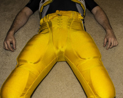 strappedown:  Nothing gets me hornier than being in some football gear and watching the big game. My partner thinks it is important for me to stay focused on the game while at the same time having my cock and balls properly protected. This particular