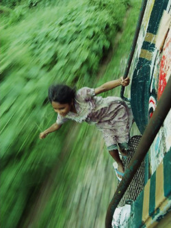 truangles:  A Bangladeshi girl hangs on to the side of a train, Unknown Source 