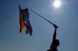 pro-gay:A gay rights activist waves a damaged rainbow flag during gay pride in St. Petersburg