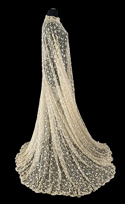  NORMA SHEARER MARIE ANTOINETTE LACE CAPE  A lace cape worn by Norma Shearer as the title character in her Academy Award nominated role in Marie Antoinette (MGM, 1938). The lace has a floral and foliate pattern and is embellished with hand sewn artificial
