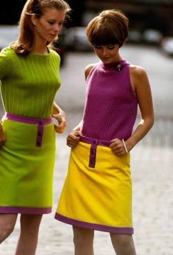 isabelcostasixties:  Two unidentified models, one in a green sweater and green skirt and the other in a purple sleeveless top and yellow skirt, pose together, New York, New York, September 1966. Both skirts feature purple trim. Photo by Susan Wood 