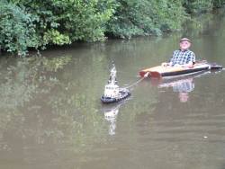 mjmoss: laughingsquid:  A Tiny Remote Controlled Tugboat Tows a Man in a Kayak Along a Canal in the English West Midlands  Me aged 60. 