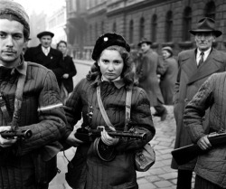 arrogant-bastard-american:  One of the most famous photos of the short-lived Hungarian Revolution, a determined-looking young woman dressed in a looted Soviet parka carrying a distinctive PPsH-41 sub machine gun. 