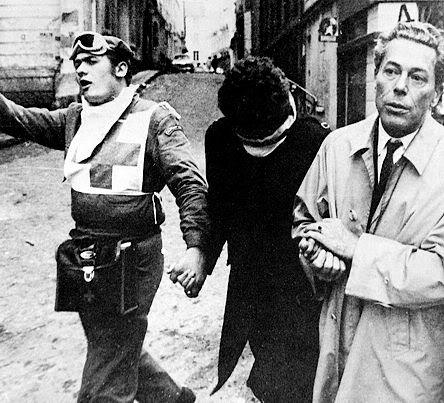 Jacques Monod helps a wounded student in the 1968 student protests in Paris