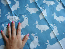 sixrabbits:  My jackalope fabric is finally here! I’m so excited to see my own  pattern printed up on a fabric. My hand is there to give a sense of  scale.  It’s now available for order herehttp://www.spoonflower.com/fabric/4254907