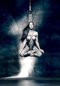 This is an excellent piece of bondage.  Meditation on her place.  I particularly like the peace sign ring just over her head.  Well rigged and a wonderful piece of art.