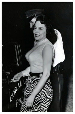 Vintage press photo dated from early March of ‘58, features stripper Evelyn West being carted off to the Coral Gables jail, in Florida.. She was arrested for throwing over-ripe tomatoes at film actress Anita Ekberg, who was on a personal appearance