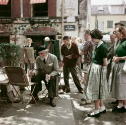 theniftyfifties:  A street scene in Montmartre, Paris, 1950s. Photo by Robert Capa. 