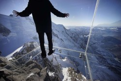 untrustyou:  A journalist wore slippers to protect the glass floor of the ‘Step Into the Void’ enclosure at Aiguille du Midi mountain in the French Alps. The structure is a five-sided glass structure installed on the top terrace of the mountain, with