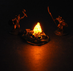 sturmtruppen:  two-bugbears:  These are small, light up camp fires we make for miniature war gaming and role playing games. They are in the 28mm scale, and flicker and provide a scale light source that looks fairly realistic on the tabletop. We thought