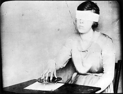 Mary Evans - A girl, blindfolded, uses the planchette with a pencil fixed in it, hoping to receive by &lsquo;automatic writing&rsquo; a message from the spirits in the beyond.