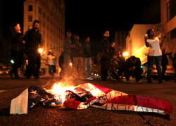 politics-war:  A flag burns during a protest after George Zimmerman was found not guilty in the 2012 shooting death of teenager Trayvon Martin, early Sunday, July 14, 2013, in Oakland, Calif. 