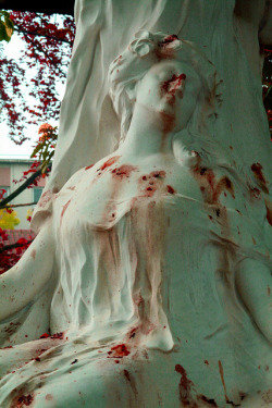 sixpenceee:Flower petals cause the appearance of blood stains on the grave of opera singer Jane Margyl in Batignolles cemetery in Paris.