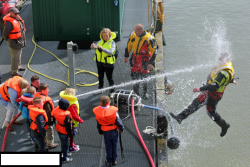 uniformstories:  What happens when you let kids play with the hose during a Coast Guard demonstration.