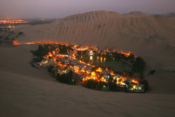 Tan YilmazHuacachina oasis, near Ica city, on the peruvian desert coast, taken from the top of the dunes at dusk.