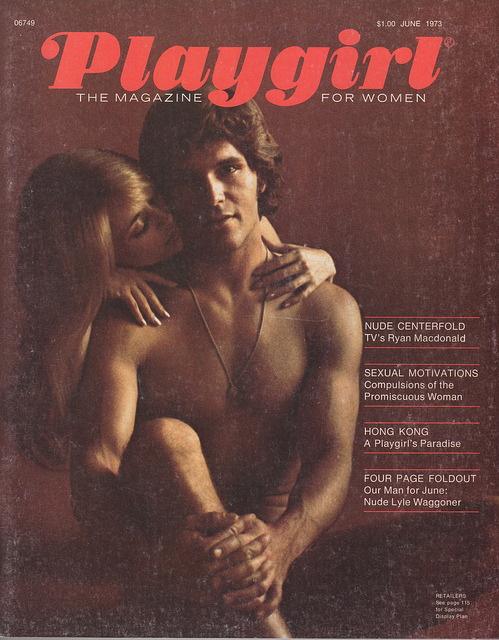 Woman looking at playgirl magazine