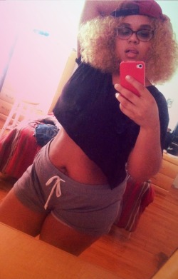 fatpeopleofcolor:  [image description: an afro latina woman stands in front of a mirror in a bedroom with iphone taking selfie in a black crop top and heather gray draw string shorts and cap worn backwards. one arm is held up behind head.] 