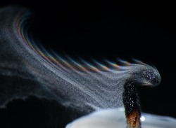 thesciencellama:  Smoke Droplets with Refraction “Smoke resolved into its component droplets of wax, with zones of refraction making rainbows on the upper edge.”